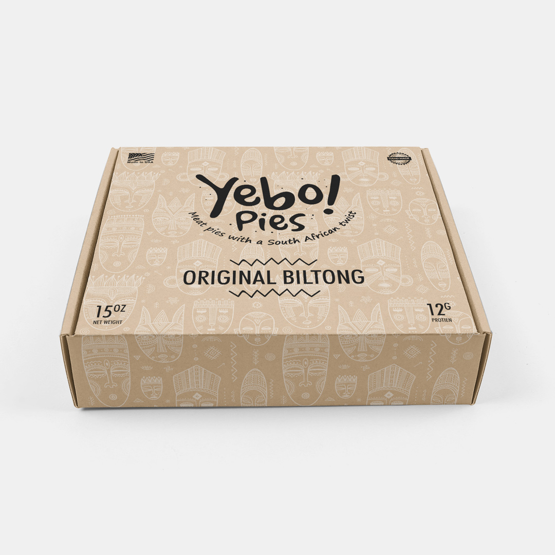 Yebo! Pies individual pie box, warm kraft with the mask illustration running full-bleed.